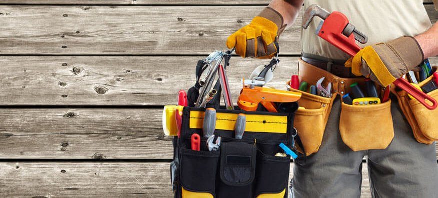Handyman with tool belt and equipment ready for repairs